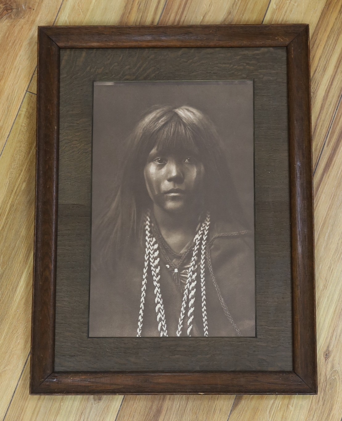 A reprinted black and white photograph of Native American girl, after Curtis, 40 x 25cm